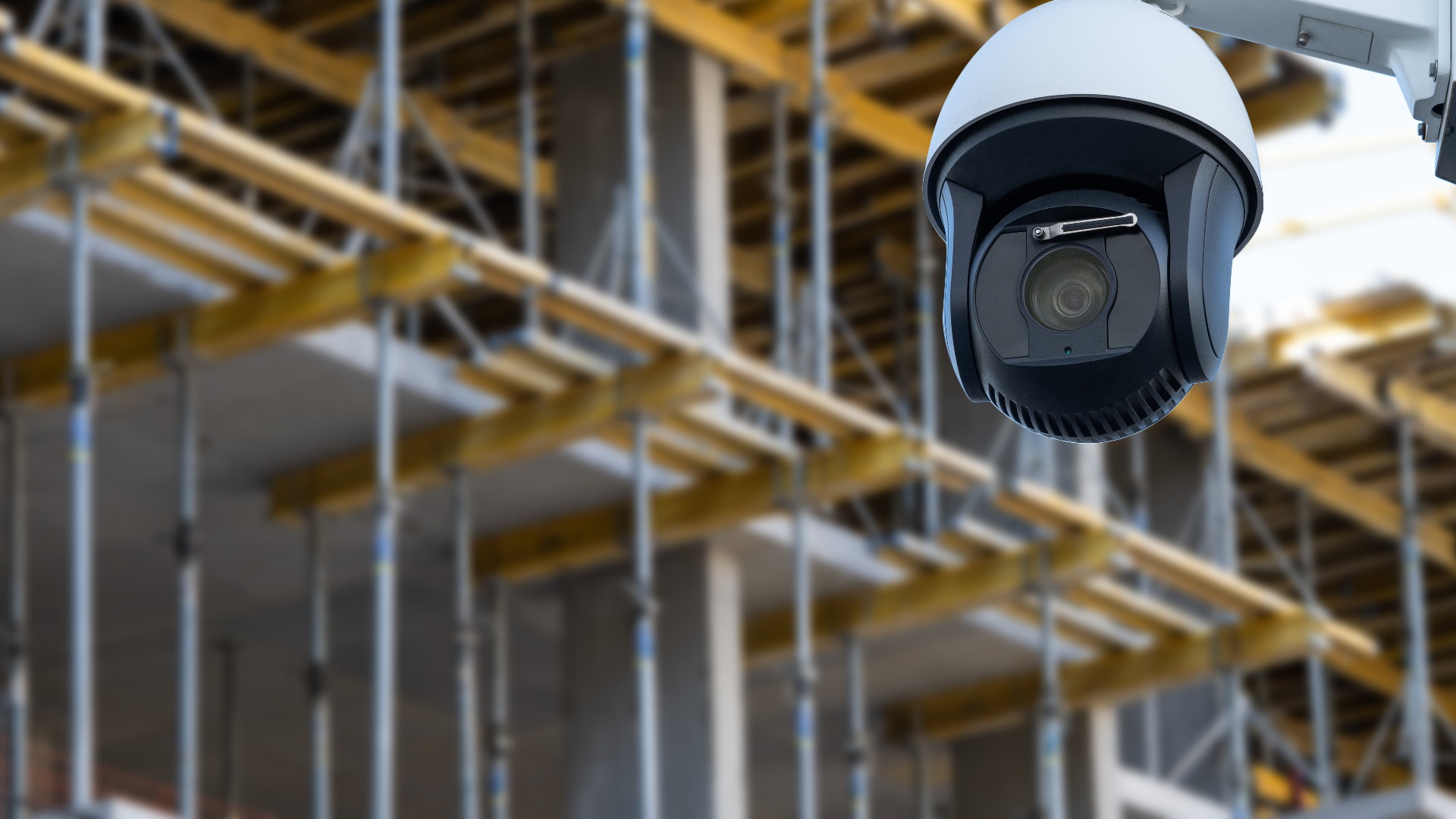 security CCTV camera or surveillance system with construction site on blurry background.