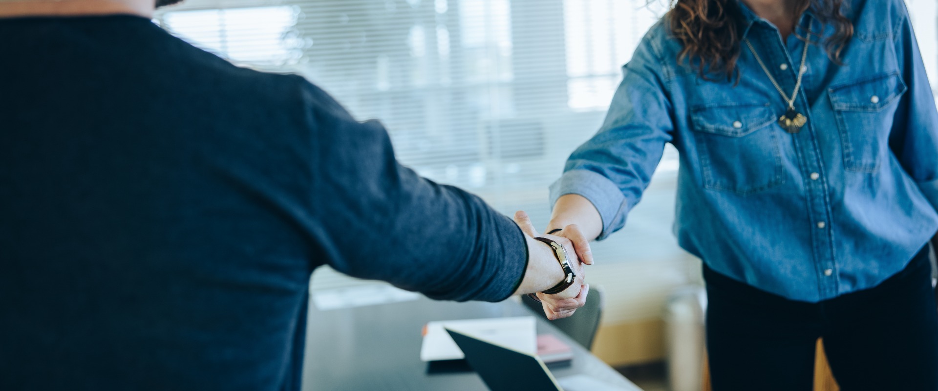 Two businesspeople handshake after meeting