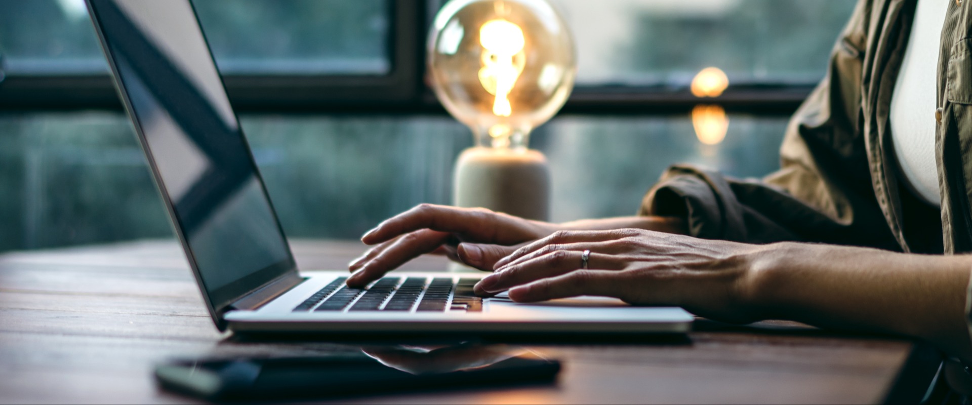Young woman working with a laptop. Female freelancer connecting to internet via computer. Businesswoman at work